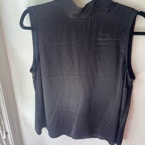 Lovely delicate silk like material with high neck. Never worn